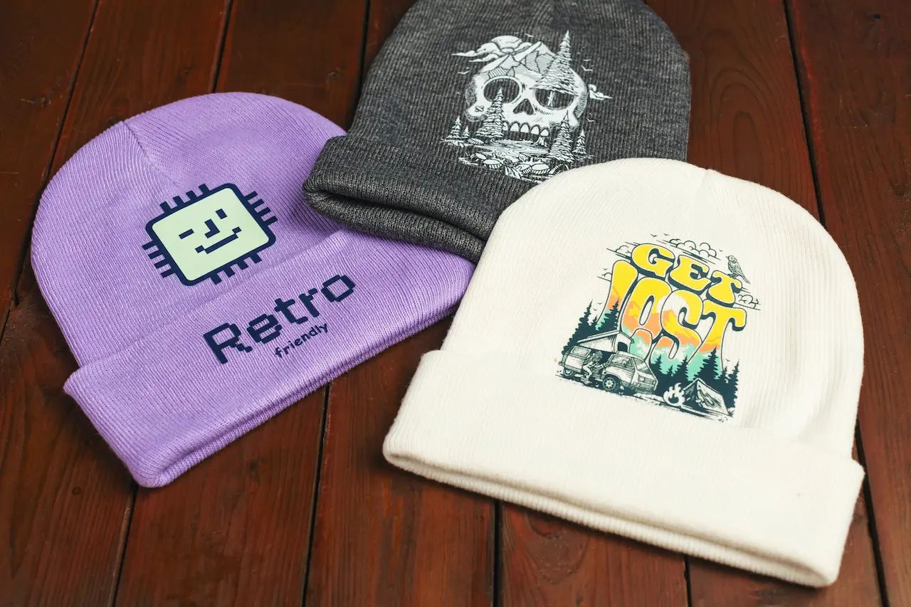 Three knit hats decorated with custom full-color transfers