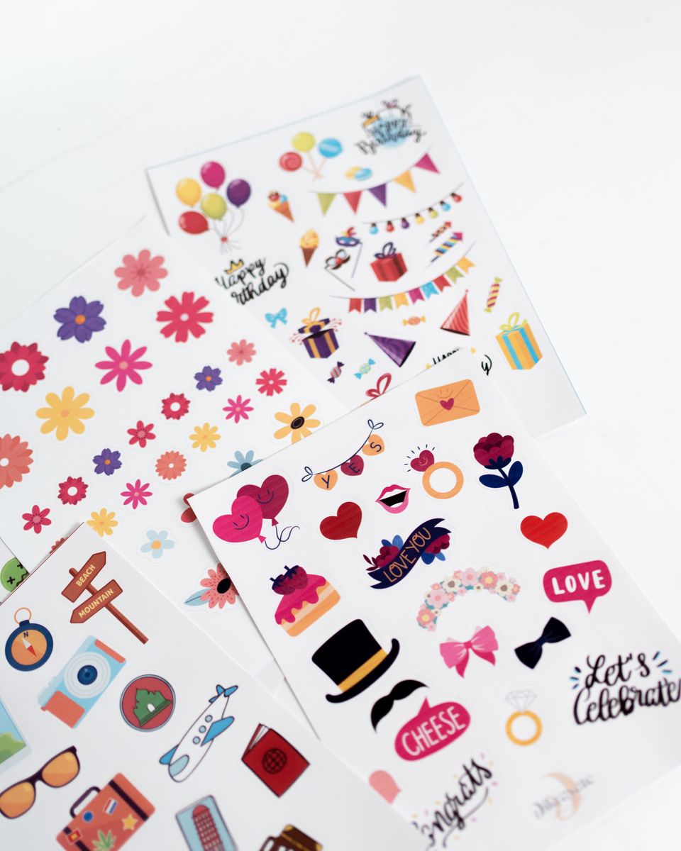 Colorful unbranded sticker sheets arranged on a light surface